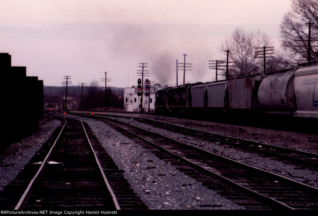 Its getting dark as a northbound train heads for the signals at the north end of the yard